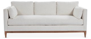 White linen sofa with wood base